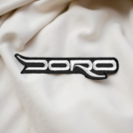 Doro Logo Embroidered Patch – White Rock Band Iron-On Badge for Jackets & Bags